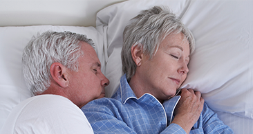 Oder couple sleeping in bed